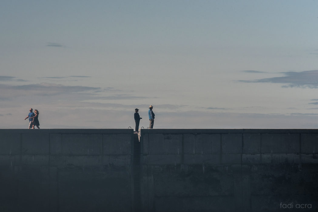 photo of two people on a pier