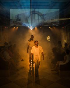 performers with mist and projection in the background