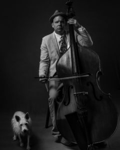 musician with bass and dog