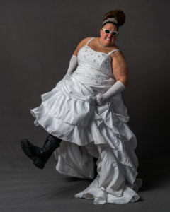 woman in wedding gown and boots kicking