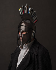 man in greek warrior helmet with pens