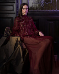 seated model in silk dress