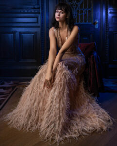 seated model in feathered dress