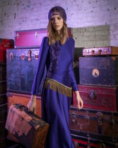 woman in purple dress with vintage luggage