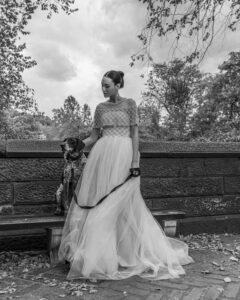 model in bridal gown in park with dog