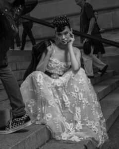 model seated on steps wearing bridal dress