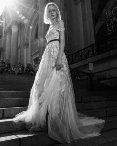 woman on steps dressed in wedding dress