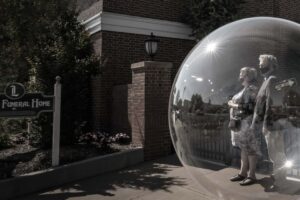 woman and man inside a bubble at funeral home